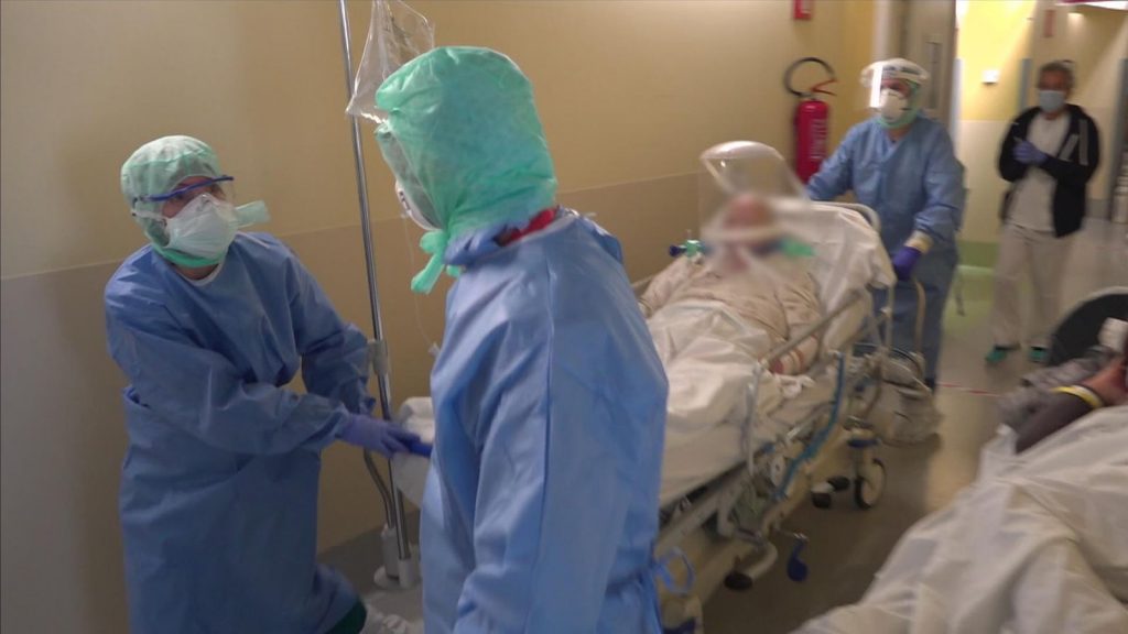 Italy, Bergamo - Hospital staff push a gurney carrying a man on a mobile respirator